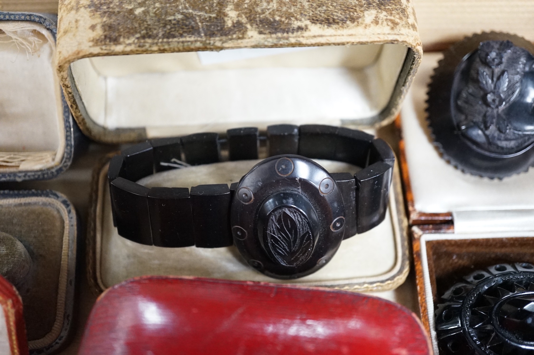A group of assorted Whitby jet jewellery including three brooches, largest approximately 47mm, three bracelets and a group of French jet? loose pieces.